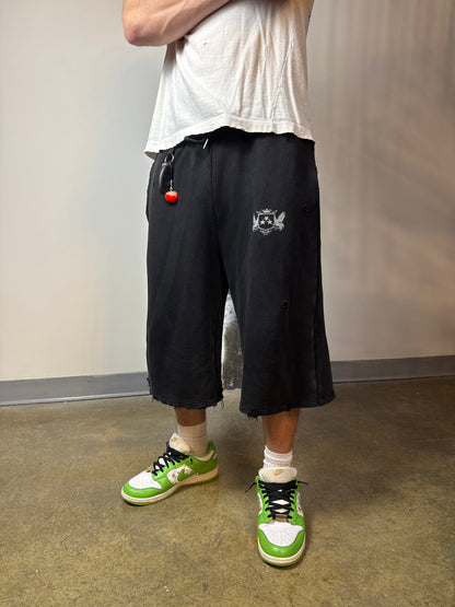 Sulfur Black sweat shorts worn with a white T-shirt and green sneakers