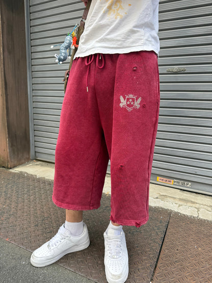 Wine Red sweat shorts worn with a white T-shirt and white sneakers
